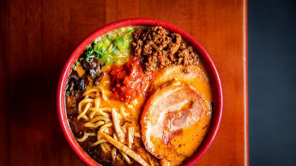 Spicy Miso Ramen · Pork broth and red and white miso served with thick noodles topped with chashu pork jowl, ground pork, kikurage, menma, scallions, black garlic oil.