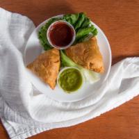 Samosa(Vegan)(2Pc) · A triangular pastry filled with boiled potato, green peas and spices then deep fried to a go...