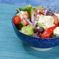 Greek Salad · Mixed greens topped with feta, tomato, cucumber, Kalamata olives, stuffed grape leaves, anch...