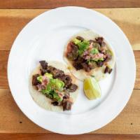 Entrana Tacos · 2 tacos with skirt steak, pico de gallo, and avocado.