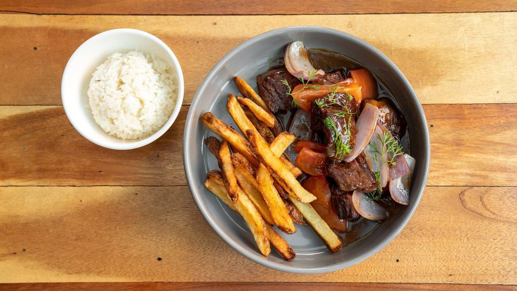 Lomo Saltado · Gluten. Prime Angus hanger steak, steak frites, stir-fried with onions, tomatoes, aji amarillo and soy sauce. Served with rice.