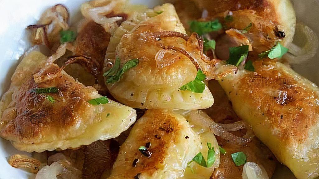 Potato & Cheddar Pierogies · Sauteed with bacon and onions, served with sour cream.