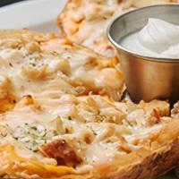Loaded Potato Skins · Topped with bacon and our three cheese blend, served with sour cream.