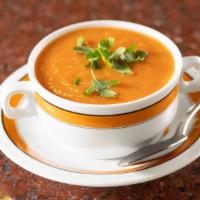 Tomato Soup · Smooth soup with pureed tomatoes and seasoning.