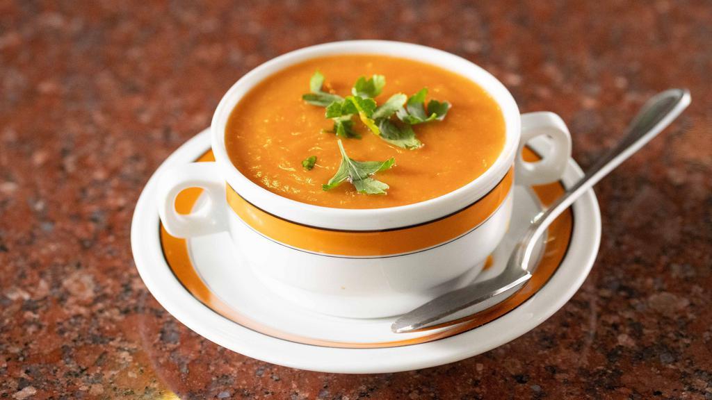 Tomato Soup · Smooth soup with pureed tomatoes and seasoning.