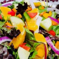 Cari-Fiesta  Salad · spring mix lettuce, onion, cherry tomato, red onion, cucumber, carrot, mango chunks, and MAN...