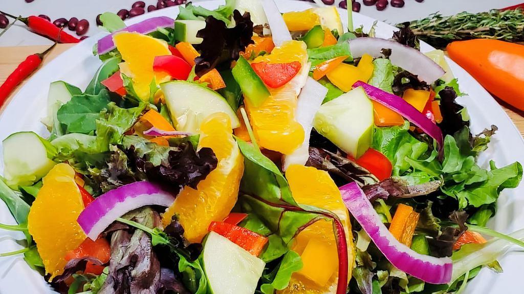 Cari-Fiesta  Salad · spring mix lettuce, onion, cherry tomato, red onion, cucumber, carrot, mango chunks, and MANGO DRESSING