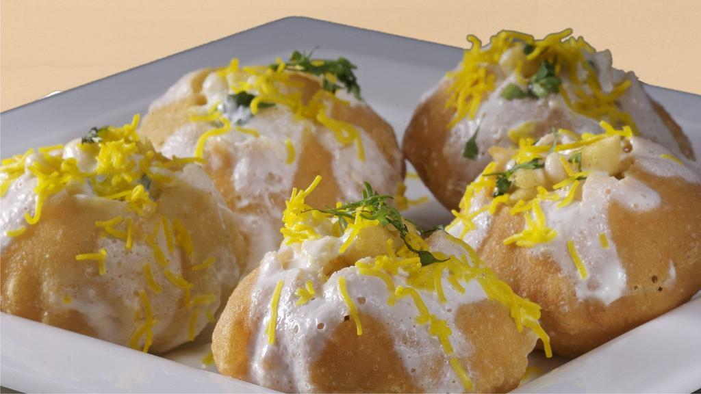 Dahi Batata	 Poori · Crispy pots filled with potato mix topped with various spices and sauces.