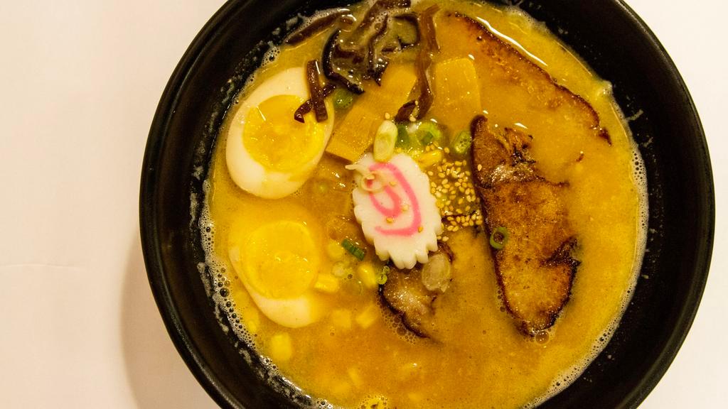 Miso Ramen · Slices of pork or chicken with soft boiled egg, bamboo shoot, sweet corn, fish cake, black mushroom, scallion and fresh ramen noodle in a miso pork broth.