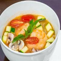 Veg Tom Kha Soup · Creamy coconut milk soup with zucchini, mushroom, and tomato. Hot and Spicy.