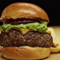 Guacamole Burger · Served with melted cheddar cheese, warm corn tortilla chips, guacamole & sour cream on the s...