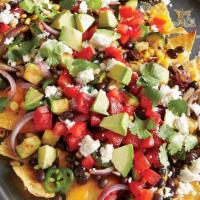 Vegetarian Nachos · Warm corn tortilla chips, smothered with refried black beans, cheddar, and jack cheese, topp...