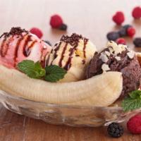 Banana Split · 3 scoops of ice cream, sliced bananas, shaved almonds, cherry and hot fudge topped with vani...