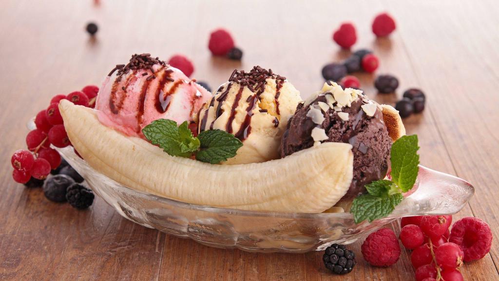 Banana Split · Three Scoops Of Ice Cream, Sliced Bananas, Shaved Almonds, Cherry, Hot Fudge Topped With Vanilla Chantilly Cream.