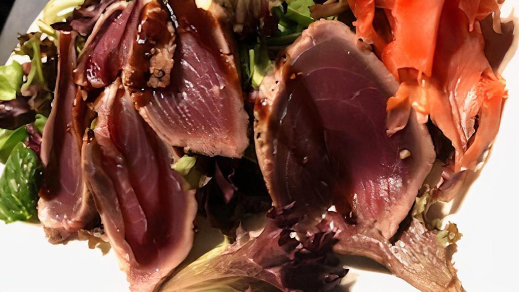 Pepper Seared Sashimi Tuna · Pickled Ginger, Wasabi, Spicy Mixed Greens, Soy drizzle.
