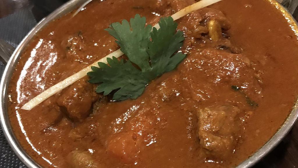 Lamb Rogan Josh · Lamb cubes cooked with onion, tomatoes and yogurt spiced with the chef's special mix and garnished with cilantro. Served with basmati rice.