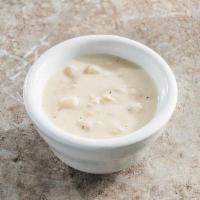 Cup Of New England Clam Chowder · Our famous clam chowder, made with clams, potatoes, celery, onion & bacon.