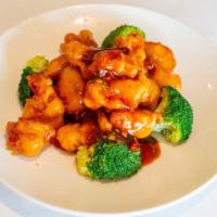 General Tso Chicken · Chunks of crispy chicken glazed with spicy sweet sauce, accompanied by steamed broccoli.