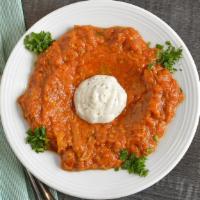 Kashk-Bademjan (Lunch) · Cooked eggplant in our home-made tomato sauce, topped with yogurt.