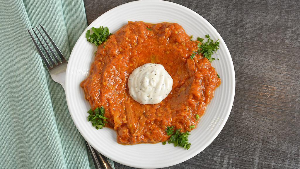 Kashk-Bademjan (Lunch) · Cooked eggplant in our home-made tomato sauce, topped with yogurt.