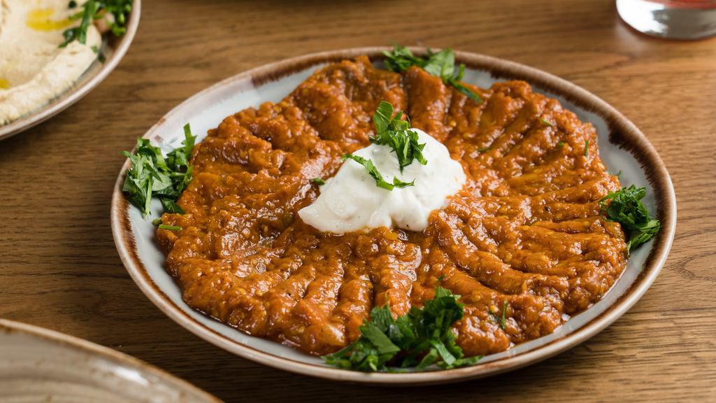 Kashk-Bademjan Dinner · Cooked eggplant in our homemade tomato sauce topped with yogurt.