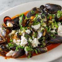 Midia Saganaki · Mussels steamed with tomato and feta.