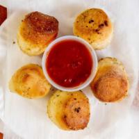 Garlic Knots · Six pieces. With side of sauce.