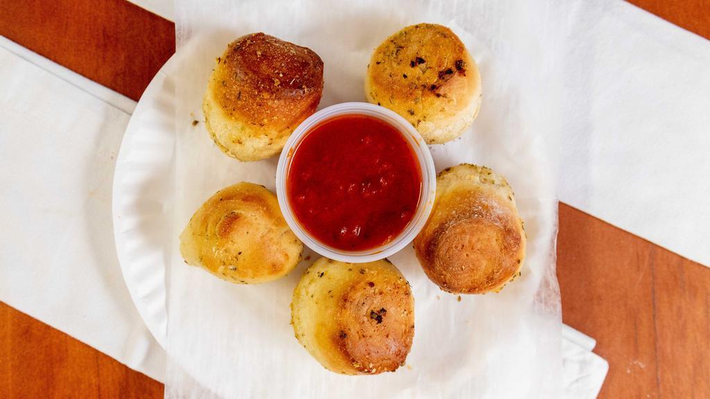 Garlic Knots · Six pieces. With side of sauce.