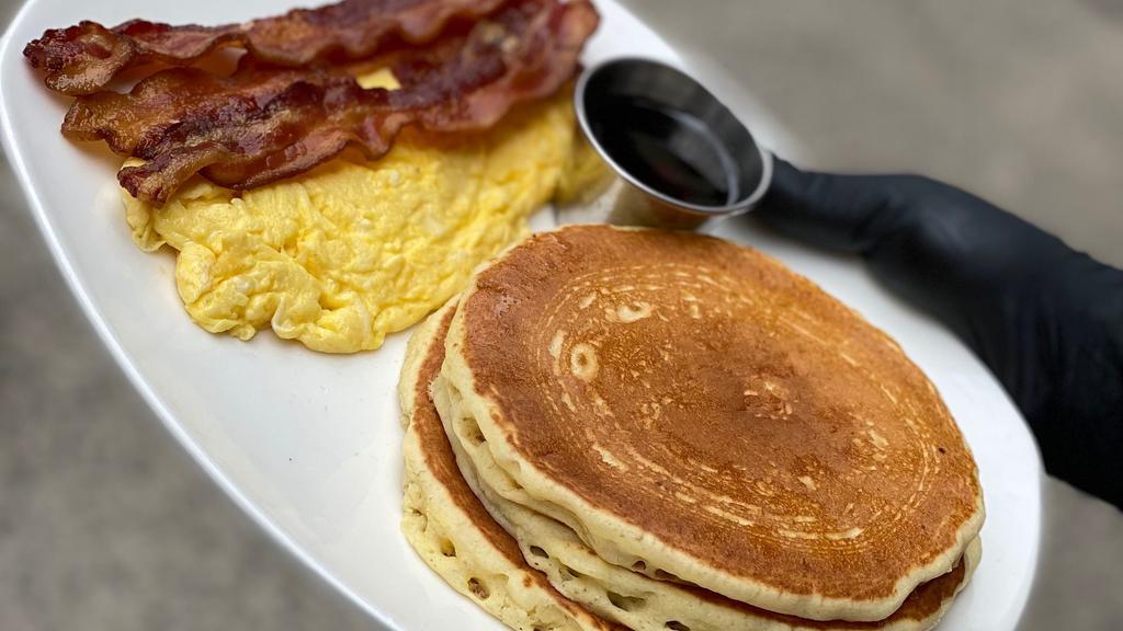 Pancakes Deluxe · Comes with two eggs and choice of bacon, ham or sausage. Served with butter and syrup.
