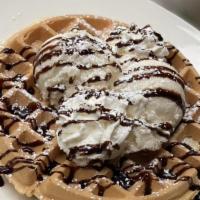 Belgian Waffle Sundae · Topped with ice cream, chocolate syrup and whipped cream. Served with butter and syrup.