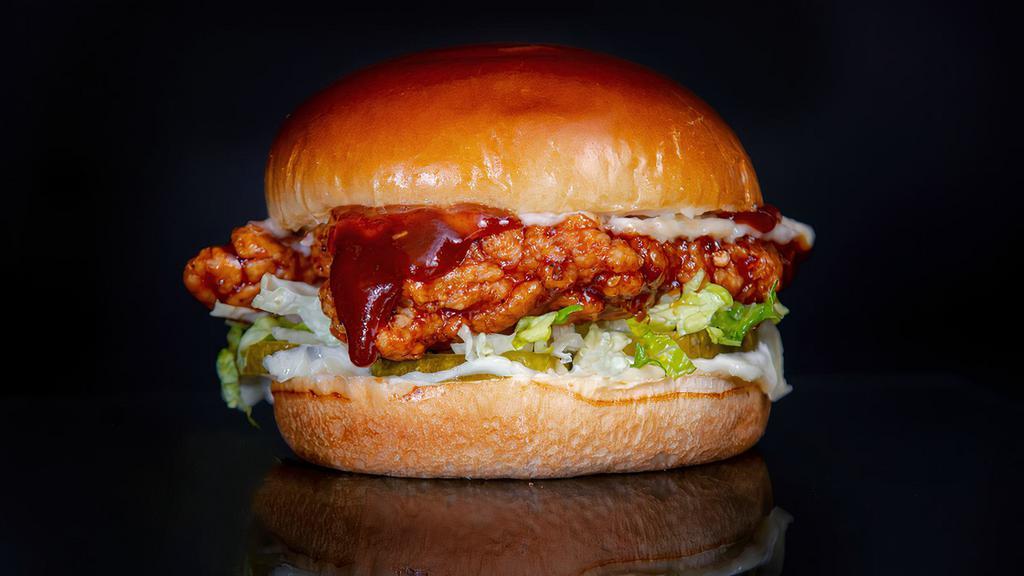The Bbq Sandwich · Cornflake Crusted Chicken Breast seasoned in our signature spice blend, tossed in BBQ sauce, in between a toasted brioche bun with pickles, shredded romaine, and mayo.