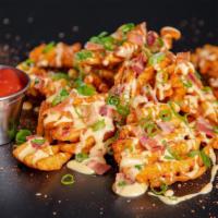 Loaded Waffle Fries · Waffle fries seasoned in Sam's New Orleans style spice, topped with Cheese Sauce, Bacon Crum...