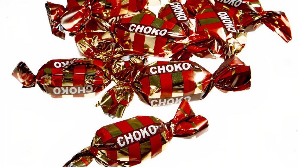 4Oz Choko · This milk chocolate and caramel-toffe wrapped candy is the square-shaped and softer cousin of the Dumle. 
Ingredients: Glucose syrup, sugar, palm oil, sugared condensed milk , whey powder ( milk ), cocoa butter, cocoa mass, whole milk powder , salt, aromas (including vanillin), emulsifiers ( soy lecithin , E476). Contains milk, soybeans.