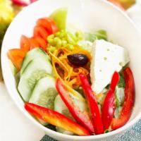 Greek Salad · Lettuce, tomatoes, cucumbers, grape leaves, bell peppers, corn, and carrots. Served with fet...