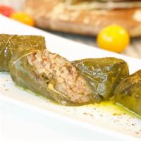 Stuffed Grape Leaves · Vegetarian, gluten free. Grape leaves stuffed with our mixture of rice, onions, pine kernels...