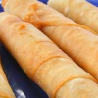 Sigara Borek · Phyllo scrolls stuffed with feta cheese. Pan-fried till golden brown.