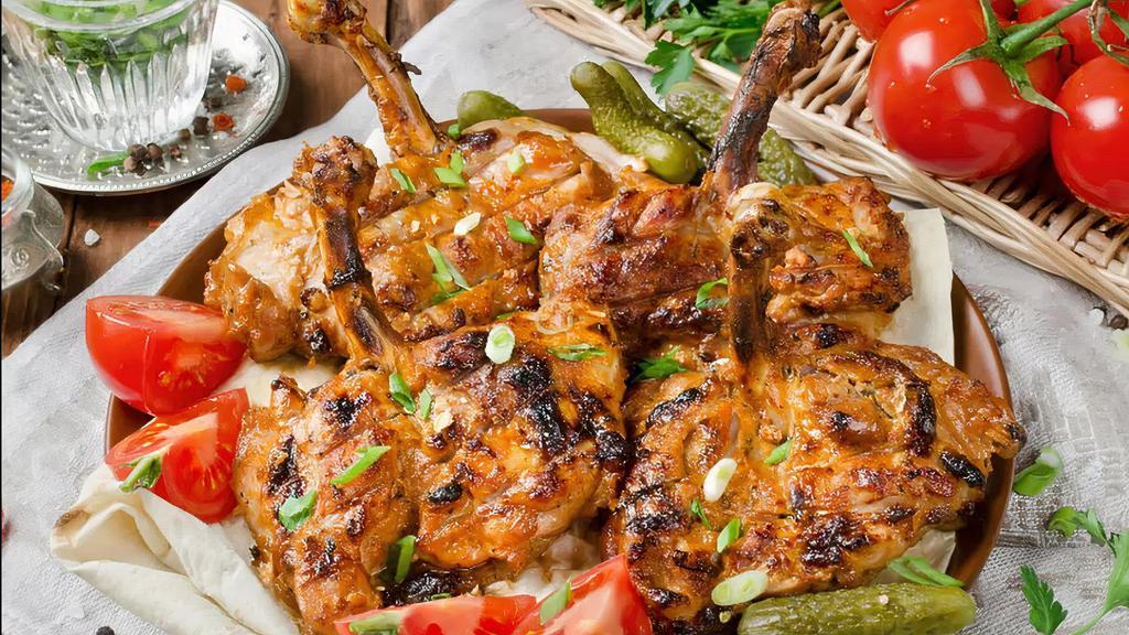 Chicken Chops · Char-grilled chicken leg and thigh with rice and vegetables.