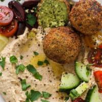 Falafel Entree · Vegetarian. Chunks of falafel balls served over a bed of hummus with rice and vegetables on ...