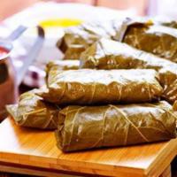 Salmon In Vine Leaves · Marinated chunks of salmon wrapped in grape leaves, char-grilled. (5pc)