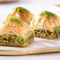 Baklava · Baked thin layered pastry filled with roasted walnuts and pistachios, flavored with a hone.