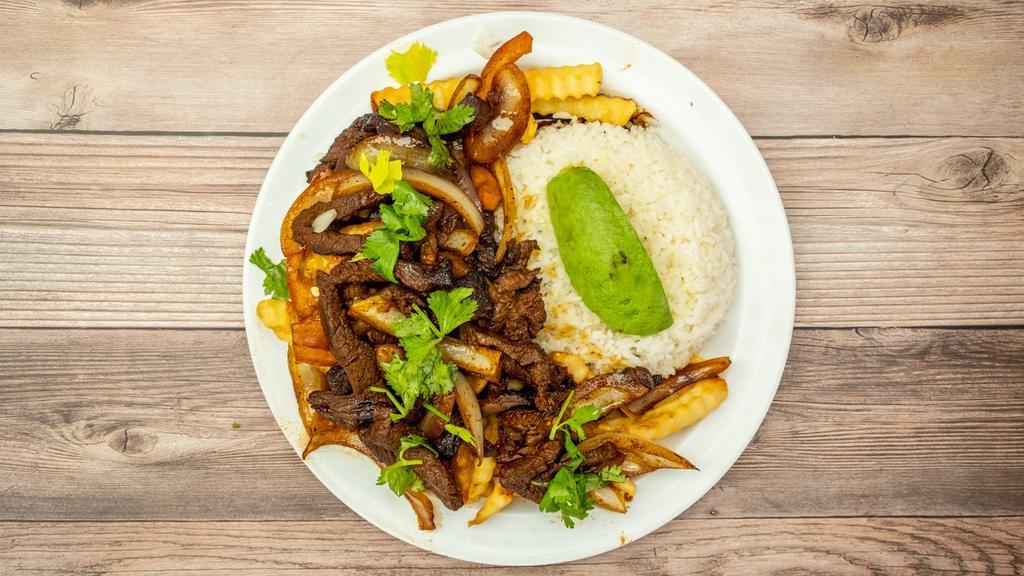 Lomo Saltado · Steak stir-fried with onion, tomato, cilantro, and soya sauce. Served with rice and French fries.