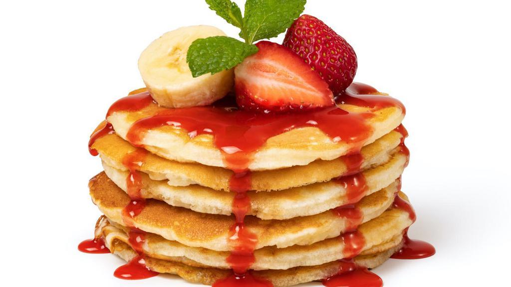 Strawberry Buttermilk Pancakes · 3 perfectly fluffy strawberry pancakes served with a side of butter and syrup