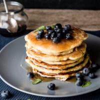 Blueberry Buttermilk Pancakes · 3 perfectly fluffy blueberry pancakes served with a side of butter and syrup