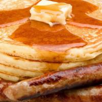 Beef Sausage Buttermilk Pancakes · 3 perfectly fluffy pancakes topped with pork sausage served with a side of butter and syrup