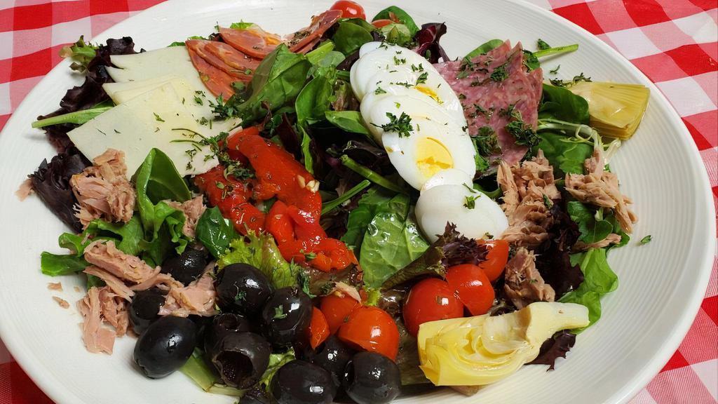 Antipasto · On a bed of mixed greens, Genoa salami, Capicola,  provolone, black olives, cherry tomatoes, tuna, hardboiled egg, artichoke hearts, and marinated roasted peppers. Served with Italian Dressing