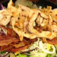 Classic Cobb Salad · Marinated grilled chicken, hard boiled egg, tomato, bacon, bleu cheese served over romaine &...