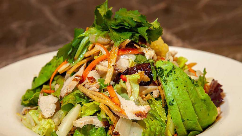 Grilled Chicken And Avocado Salad · A Fantastic Salad of Mixed Greens, Chicken, Avocado, Carrots, Cilantro and Crisp Tortilla Strips Tossed in Our Citrus-Honey Dressing and Peanut Vinaigrette