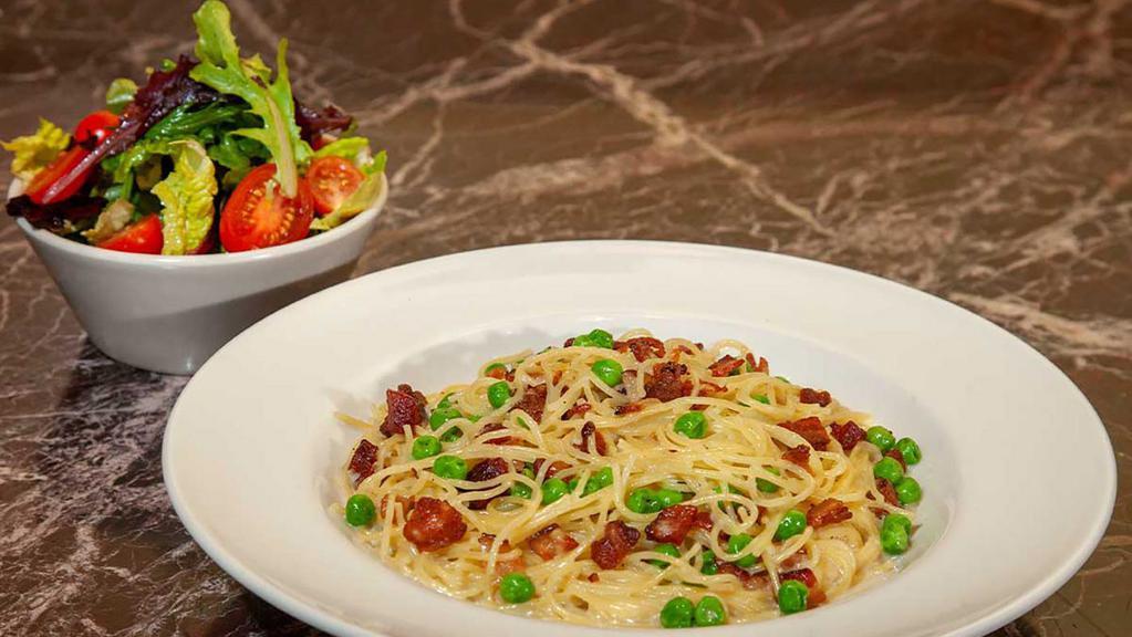 Lunch Special Pasta Carbonara · A Lunch Portion of Pasta and a Mixed Green Salad.  Imported Spaghettini Tossed with Smoked Bacon, Peas, a Touch of Garlic and a Parmesan Cream Sauce. A Classic Combination!