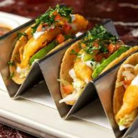 Mini Crispy Fish Tacos · Three Warm Corn Tortillas with Chipotle Sauce, Topped with Avocado, Cheese, Crema and Tomato...