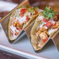 Mini Chicken Tacos · Three Warm Corn Tortillas with Chipotle Sauce, Topped with Avocado, Cheese, Crema and Tomato...